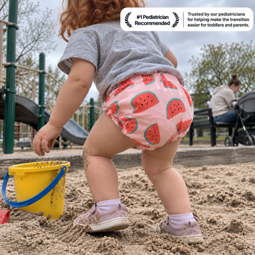 Toddler playing in a sandbox wearing Brave Bottoms watermelon-print training underwear